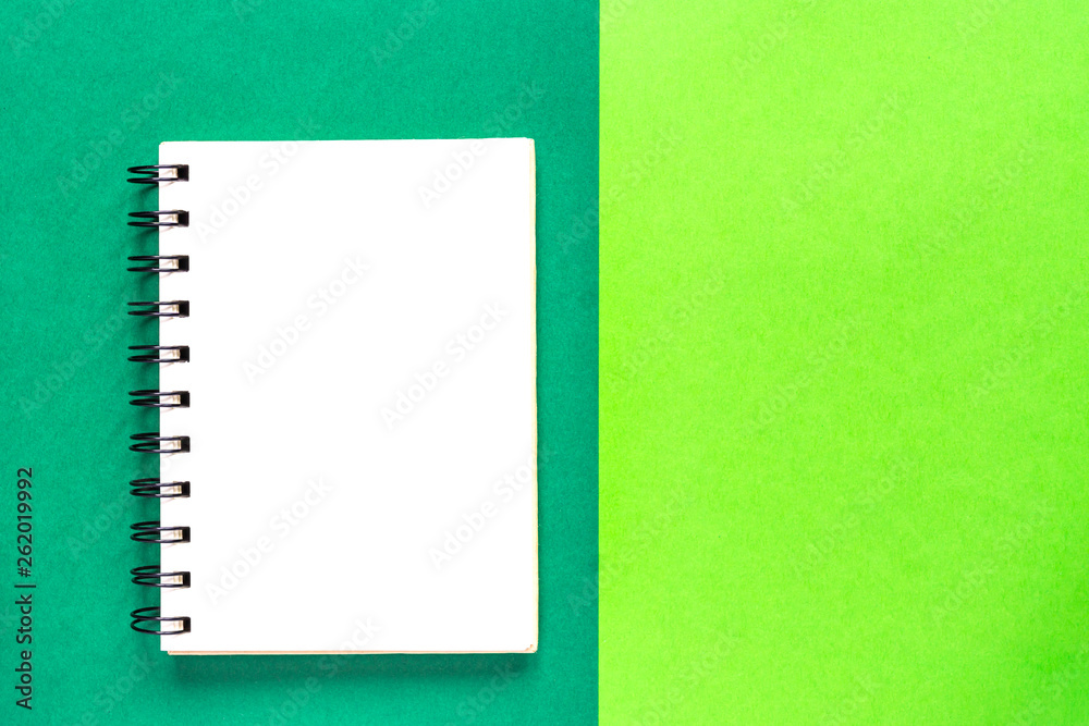 Clean spiral note book for notes on green background. Minimal business flat lay mock up Clean spiral note book for notes on green background. Minimal business flat lay mock up