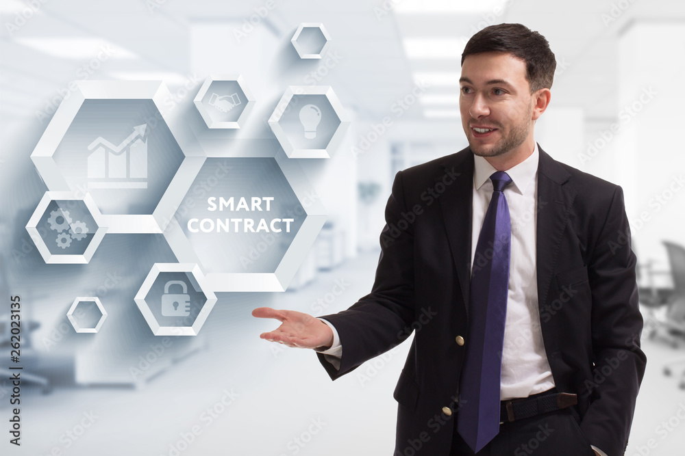 The concept of business, technology, the Internet and the network. A young entrepreneur working on a virtual screen of the future and sees the inscription: Smart contract The concept of business, technology, the Internet and the network. A young entrepreneur working on a virtual screen of the future and sees the inscription: Smart contract