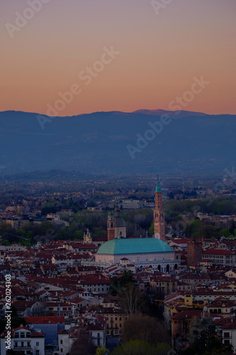 wide panorama during the sunset of the city of Vicenza and the famous monument called Basilica Palladiana with the tall Clock Tower. Vicenza  Veneto  Italy - April 2019