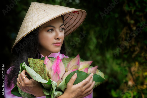 Asian women traditional vietnam is girl trolley bike to the store after the lotus flower basket..