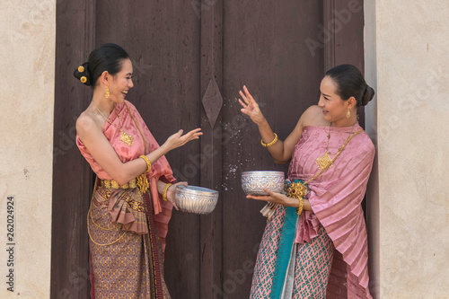 Thailand culture. Thai girls and thai women playing splashing water during with Thai Traditional costume in the temple of Ayutthaya Thailand festival Songkran festival.