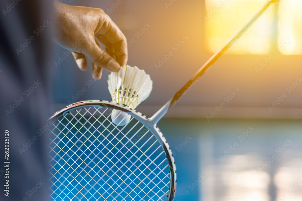 Obraz na płótnie Shuttle cock badminton in the blue court with playing badminton, Image is blurry