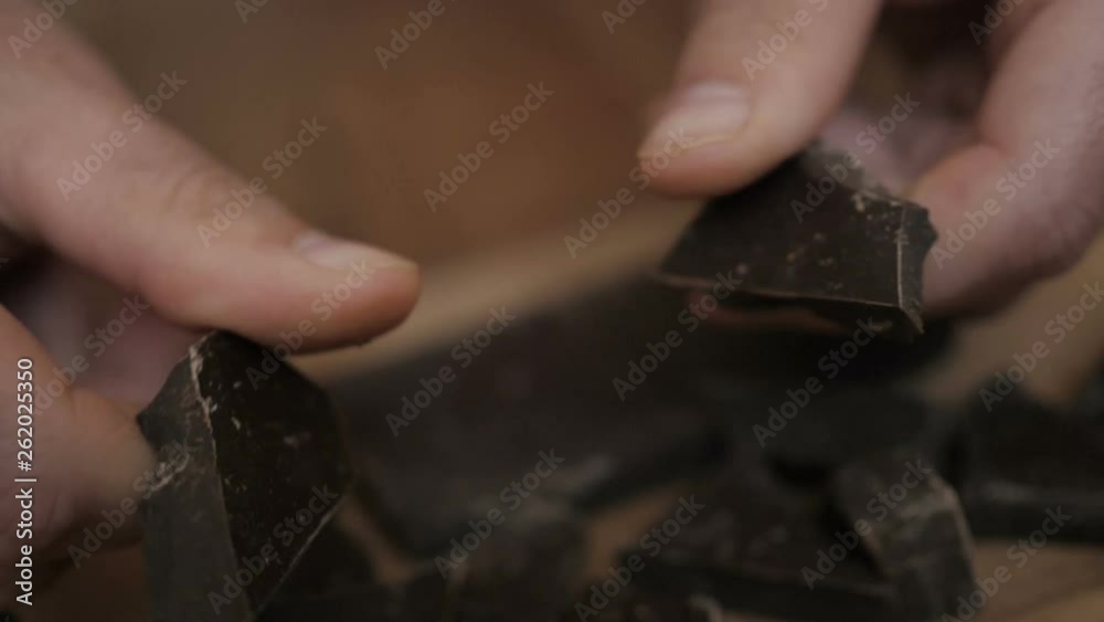 Man breaks chocolate bar. Slow motion. Close up. Hands break a bar of chocolate. Closeup. Man breaks chocolate bar. Slow motion. Close up. Hands break a bar of chocolate. Closeup.