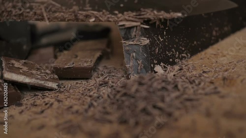 Wallpaper Mural Chopped dark chocolate on kitchen board. Chopping a Bar of Chocolate while Making Baking. Slow motion. Close up. Chop chocolate on cutting board on wooden table . Closeup. Torontodigital.ca