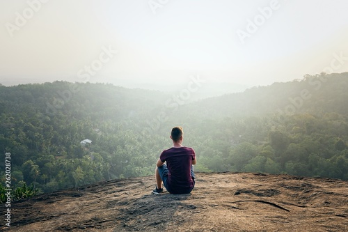 Man resting on top of rock
