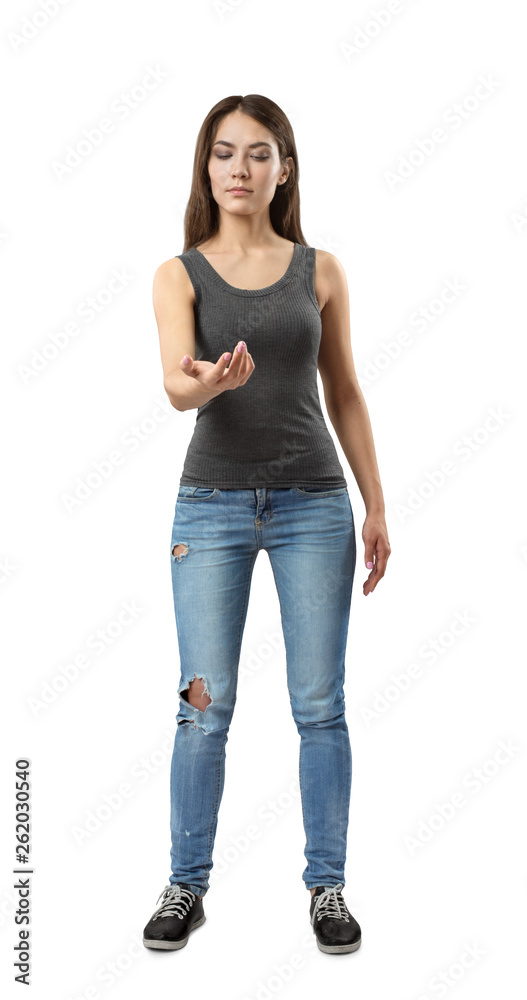 Young brunette girl wearing casual jeans and t-shirt looking at her hand on white background Young brunette girl wearing casual jeans and t-shirt looking at her hand on white background