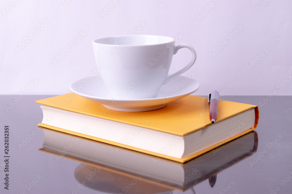 Education concept, World book day. Coffee cup, Pen and book on black table background with copy space for advertisers. Education concept, World book day. Coffee cup, Pen and book on black table background with copy space for advertisers.