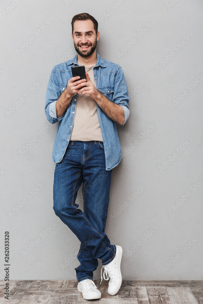 Full length of an excited cheerful man wearing shirt Full length of an excited cheerful man wearing shirt