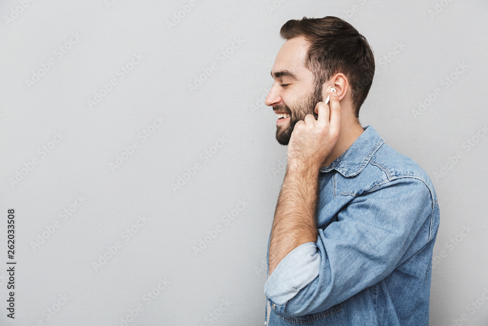 Excited cheerful man wearing shirt standing isolated Excited cheerful man wearing shirt standing isolated