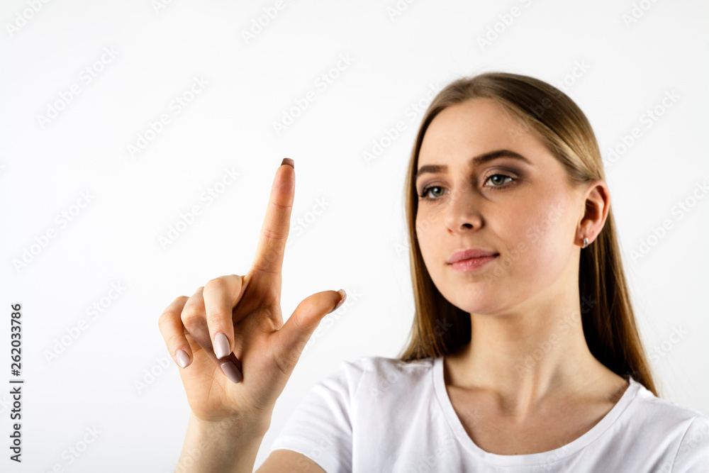 Young woman in white pushing the button Young woman in white pushing the button