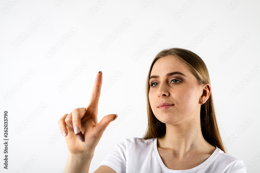 Young woman in white pushing the button Young woman in white pushing the button