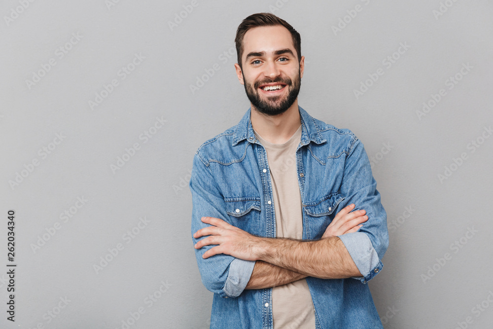 Excited cheerful man wearing shirt standing isolated Excited cheerful man wearing shirt standing isolated