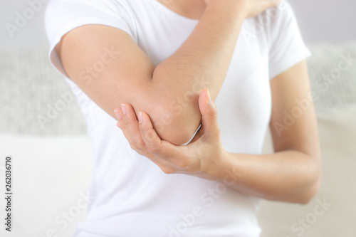 Wallpaper Mural Close up woman having pain in injured elbow. Health care and arm pain concept. Torontodigital.ca