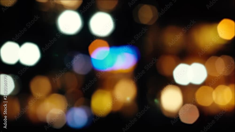 Beautiful background on dark, defocused lights of car traffic. Blue bokeh. Lens flare.