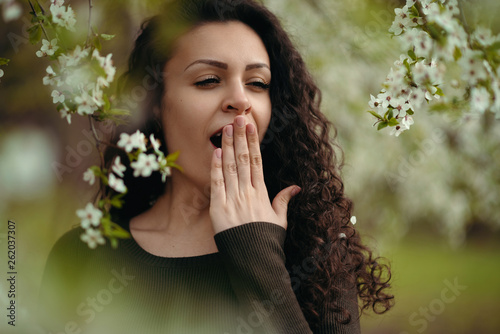 Portrait of yawning girl holding the hand posing in the nature photo