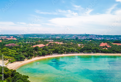 Aerial view of Nusa Dua Beach in Bali Indonesia with bay and a turquoise sea taken above from the sea during April with a drone photo