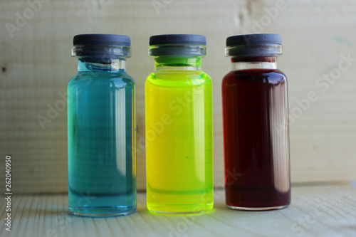 Aqueous solutions of colored dyes in glass jars.