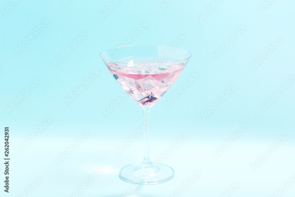 Cocktail in glass on blue background. Minimalism concept Cocktail in glass on blue background. Minimalism concept