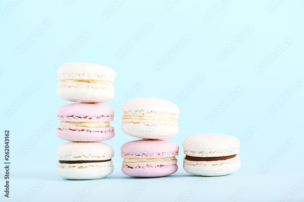 Fototapeta premium Sweet macarons on blue background. Minimalism concept