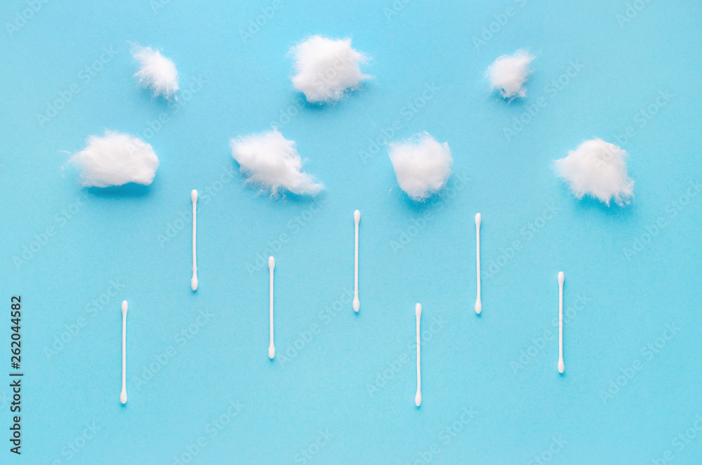 cotton wool clouds and swabs rain on blue background cotton wool clouds and swabs rain on blue background