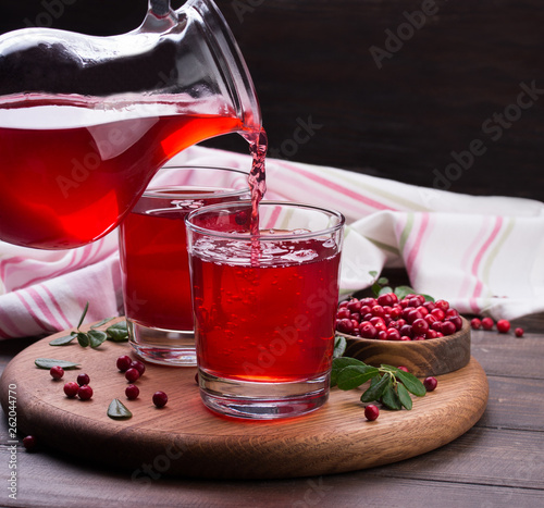 Fresh cranberry drink on wooden background. Still life