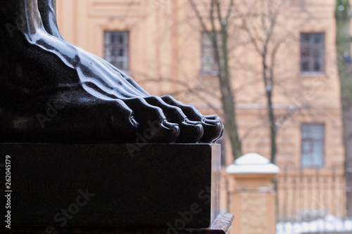 Leg - a fragment of a sculpture on one of the buildings in St. Petersburg, Russia. photo