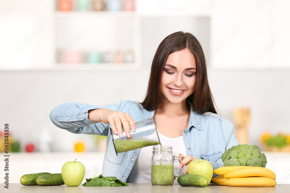 Beautiful woman pouring smoothie in glass jar Beautiful woman pouring smoothie in glass jar