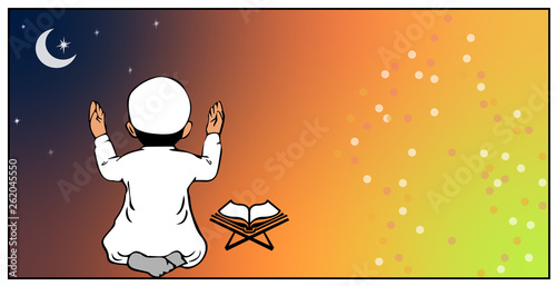 Young boy praying with holy book in front of him
