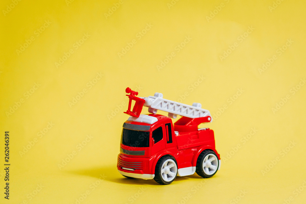 Red fire engine on yellow background Red fire engine on yellow background