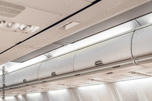 Closed doors luggage shelves in economy class passenger aircraft.