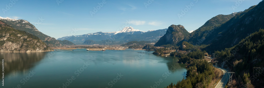Aerial panoramic view of Sea to Sky Highway with Chief Mountain in the background during a sunny day. Taken near Squamish, North of Vancouver, British Columbia, Canada.