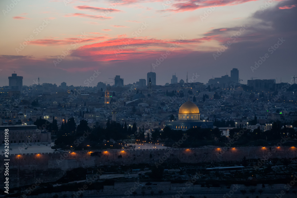 Fototapeta premium Beautiful aerial view of the Old City, Dome of the Rock and Tomb of the Prophets during a dramatic sunset. Taken in Jerusalem, Capital of Israel.