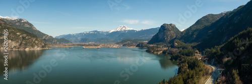 Aerial panoramic view of Sea to Sky Highway with Chief Mountain in the background during a sunny day. Taken near Squamish, North of Vancouver, British Columbia, Canada.