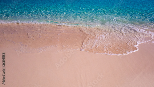 Waves from the Atlantic Ocean during a warm sunny day at the beach. Nassau, the Bahamas.