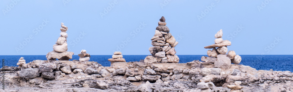 Panoramic photo of many sculptures of stacked rocks in front of the Atlantic Ocean. Panoramic photo of many sculptures of stacked rocks in front of the Atlantic Ocean.