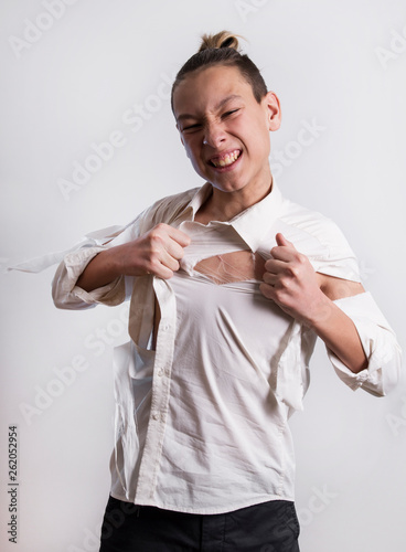 frustrated teenager tears shirt on himself