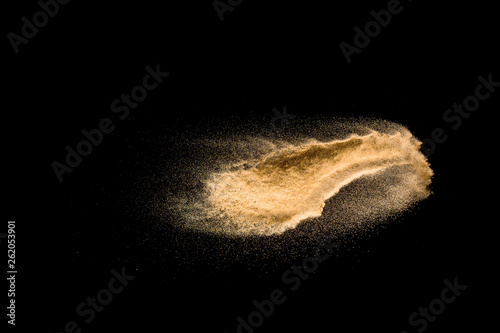Dry river sand explosion isolated on black background. Abstract sand cloud.Brown colored sand splash against dark background.