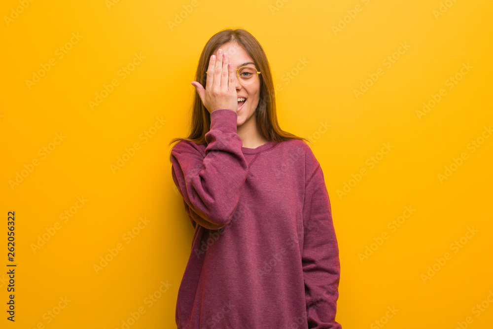 Young casual woman shouting happy and covering face with hand Young casual woman shouting happy and covering face with hand