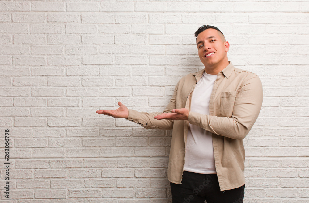 Young latin man holding something with hands Young latin man holding something with hands