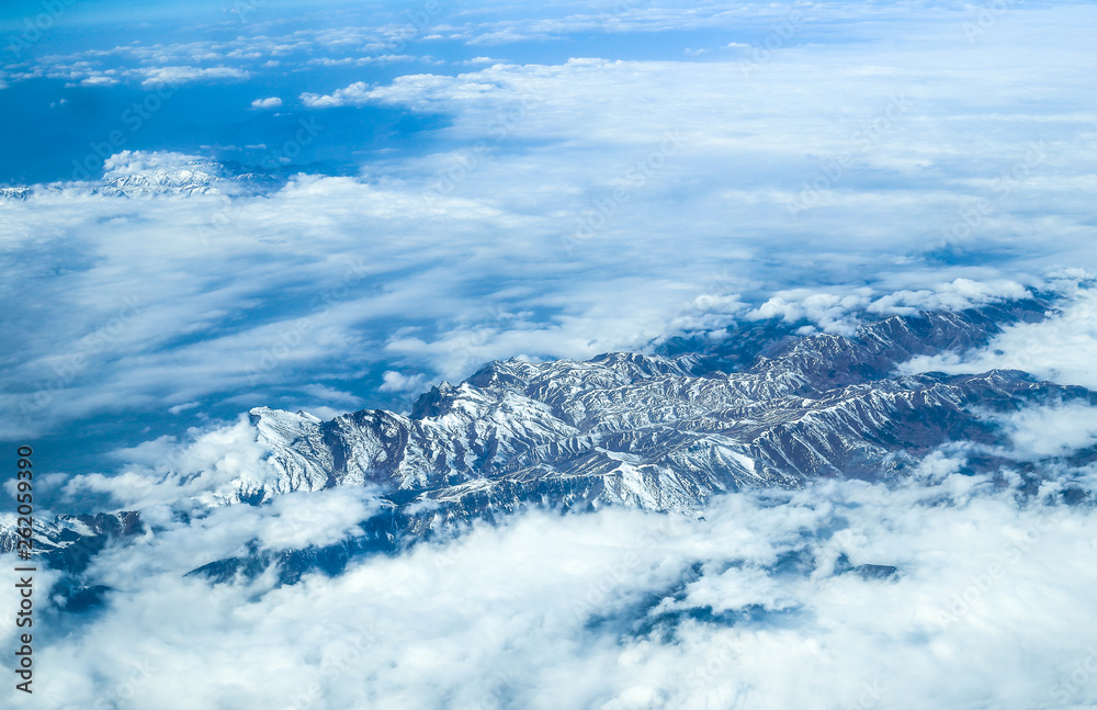 mountain range in the clouds, view from an airplane