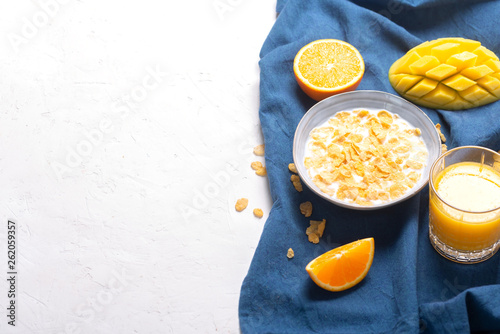 Breakfast which consist of different yellow ingredients - sereales and fruits photo