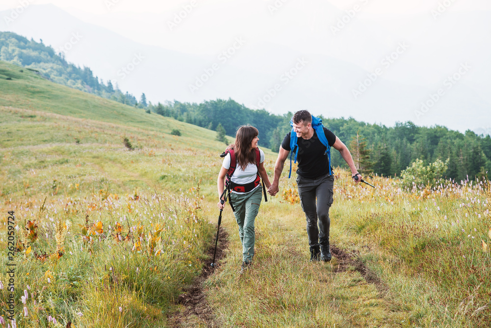 Hiking couple running at mountain,have fun