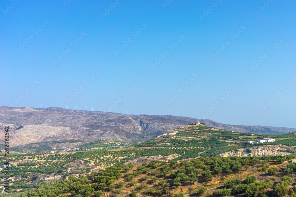 ?retan Landscape with lots of olive trees over the rolling hills, Crete, Greece and churches on top of the hills