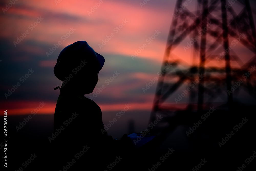 Silhouette of asian engineer working on sunset,Thailand people work on sunset