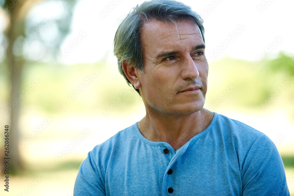 Portrait of a thoughtful mature man standing outdoors Portrait of a thoughtful mature man standing outdoors