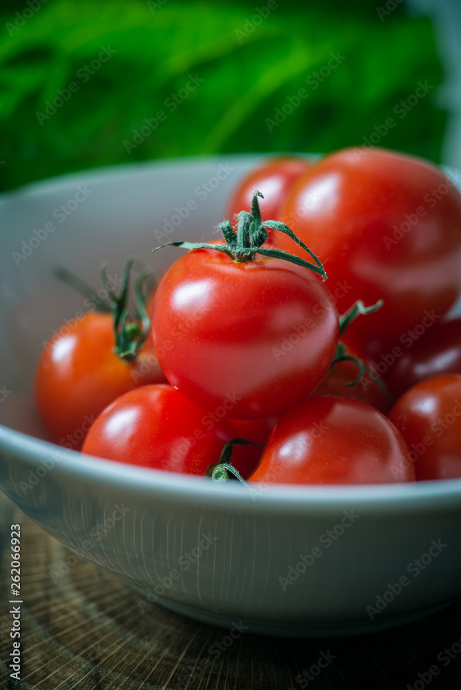 Small red cherry tomatoes on rustic background Small red cherry tomatoes on rustic background