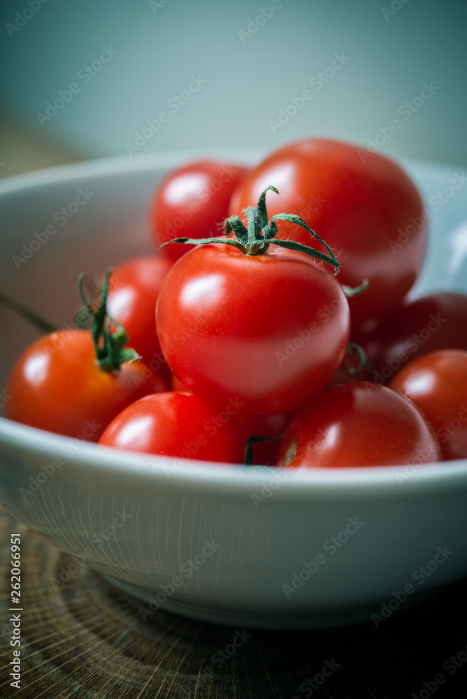 Small red cherry tomatoes on rustic background Small red cherry tomatoes on rustic background