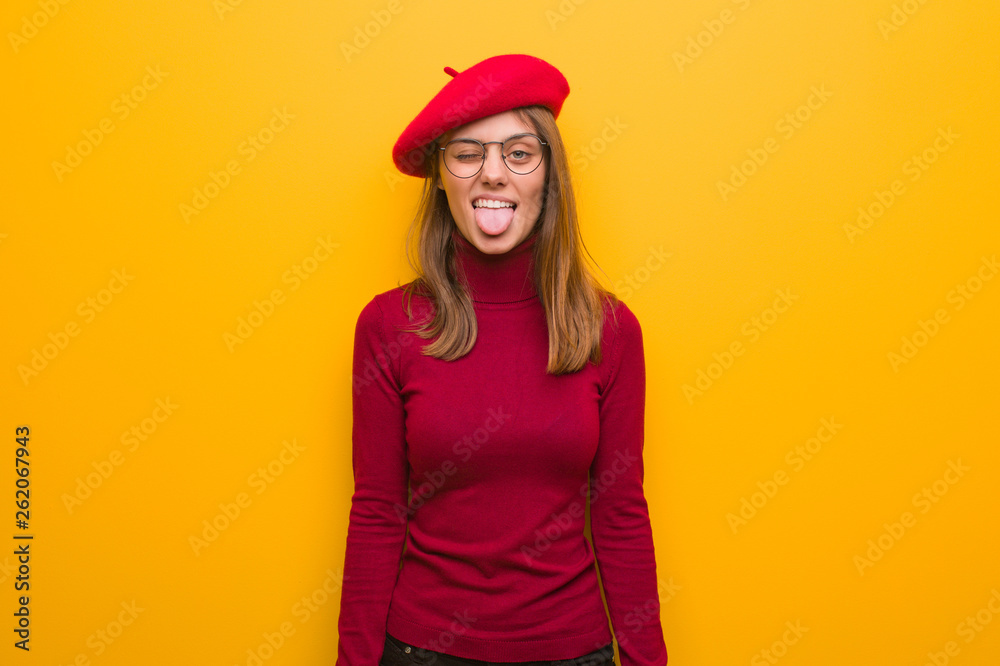 Young french artist woman funnny and friendly showing tongue