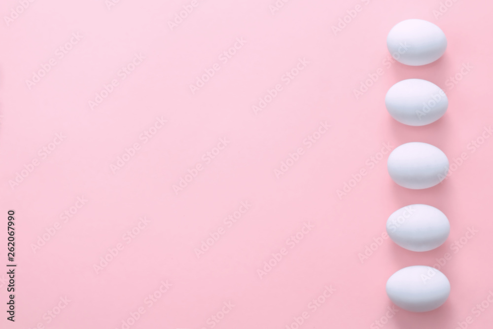 Easter eggs in a row on a pink background. Easter creative greeting card. Flat lay. Copy space. Top view Easter eggs in a row on a pink background. Easter creative greeting card. Flat lay. Copy space. Top view
