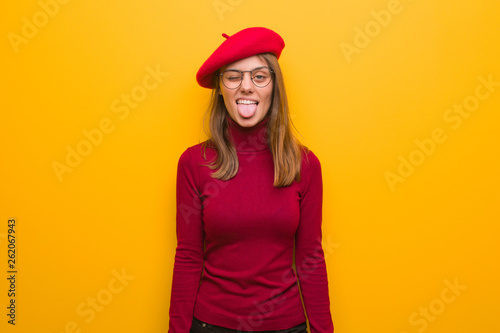 Young french artist woman funnny and friendly showing tongue